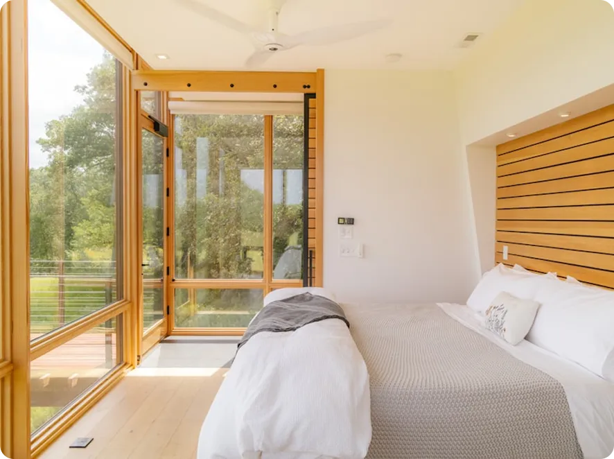 Bright bedroom with wooden slats and garden view for relocation stays